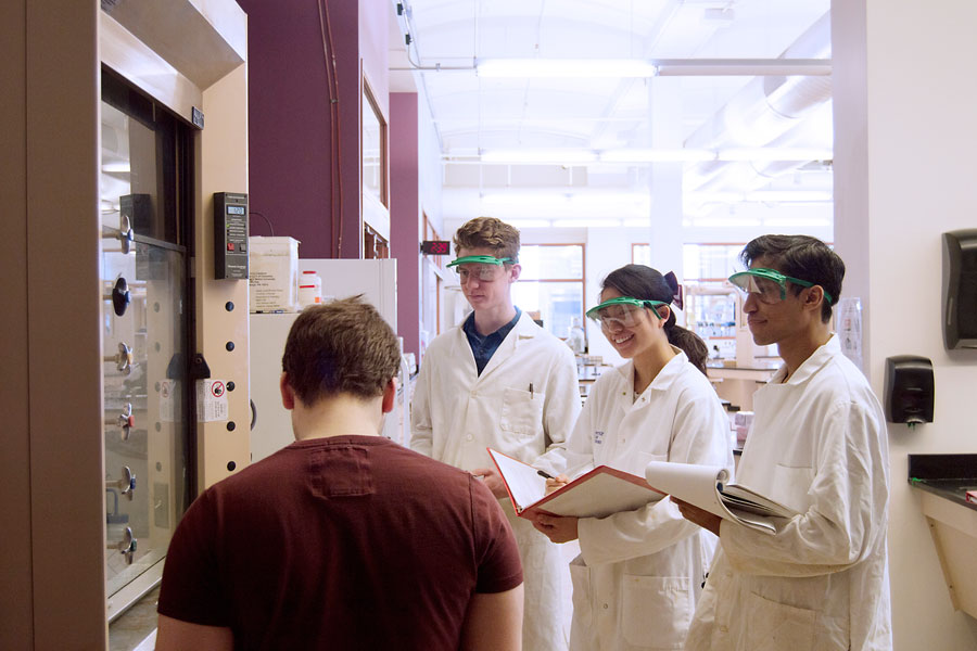 Students with instructor at lab bench