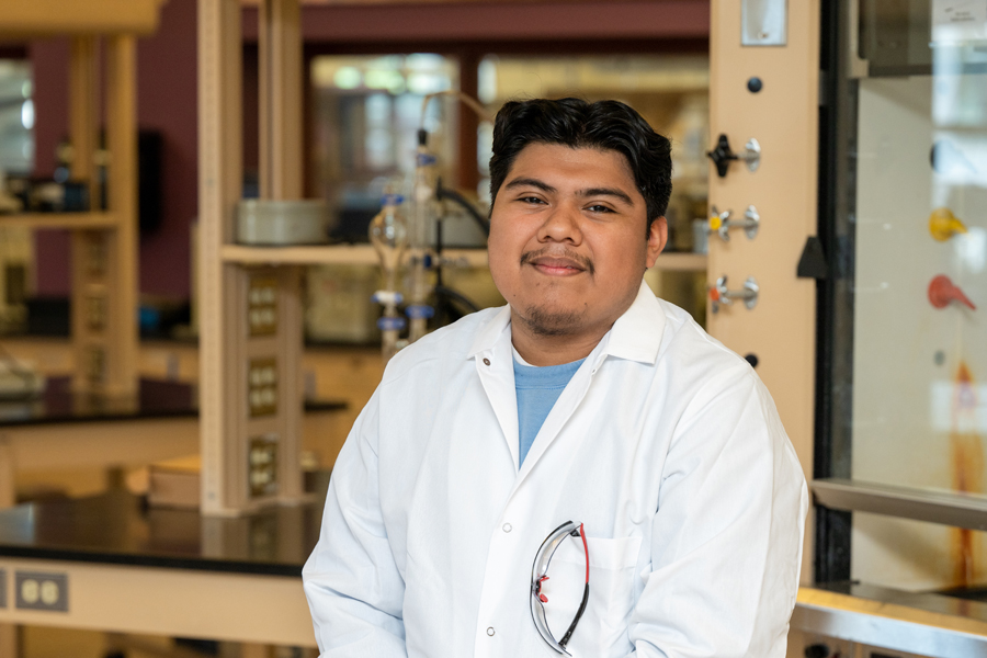 Photo of a male student in a lab coat