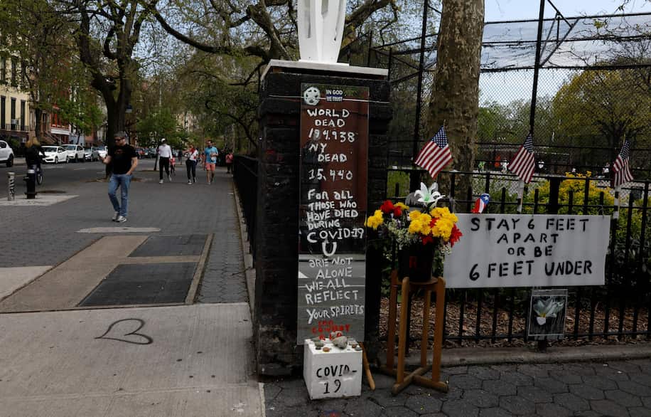 People walk past a memorial outside Tompkins Square Park in New York on Saturday. (Jason Szenes/EPA-EFE/REX/Shutterstock)