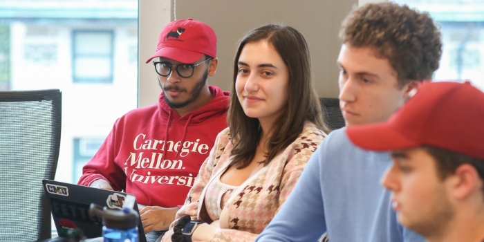 CMIST undergraduate students sitting in a class listening to a professor speak.