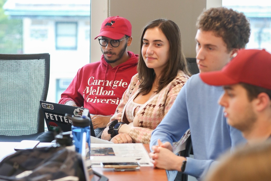 Alessandra Handrinos sitting in Geoffrey McGovern's class, with peers.