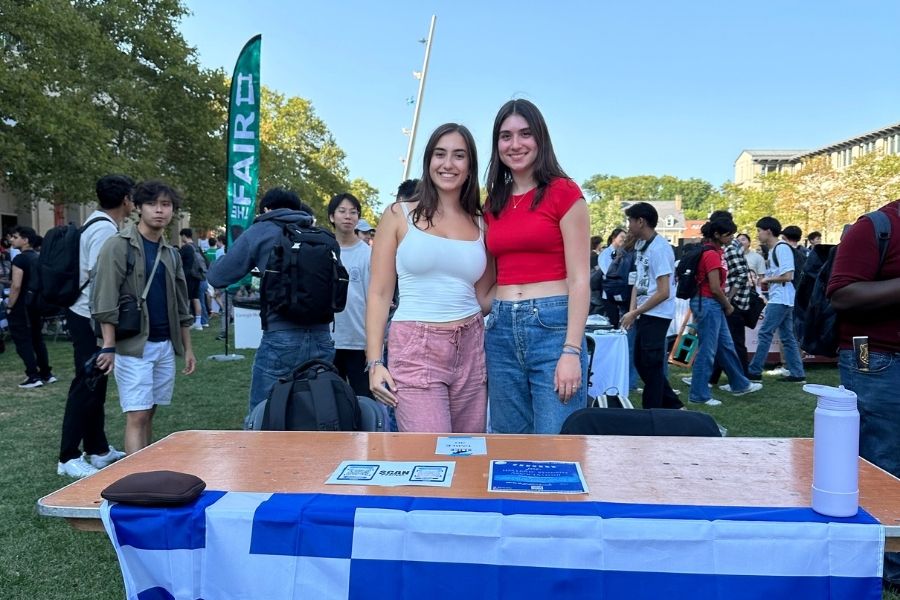 Aleksaundra (left) tabling at FAIR for a student organization she co-founded 