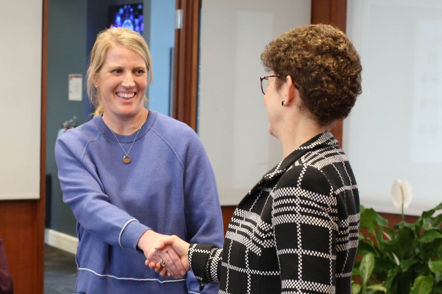 Commander Heather Thomas shakes hands with CMIST Director Audrey Kurth Cronin