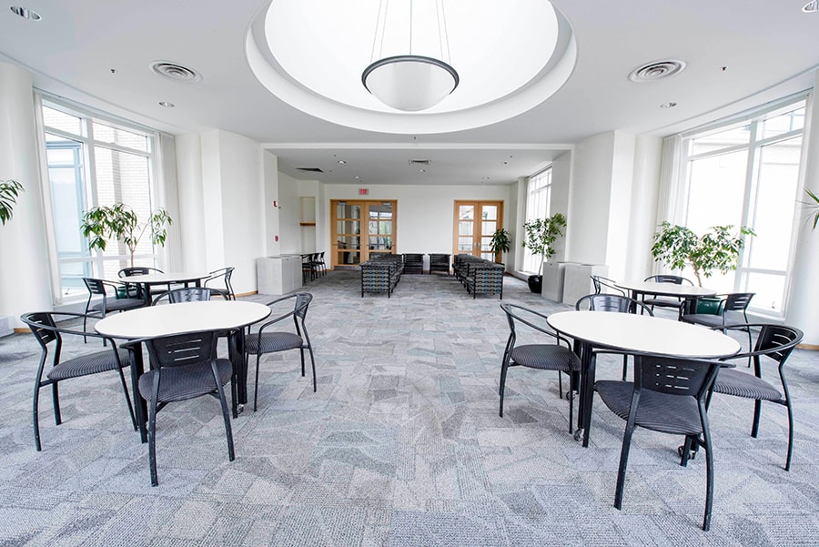 Photo of the Danforth Lounge featuring tables, seating, and the central skylight