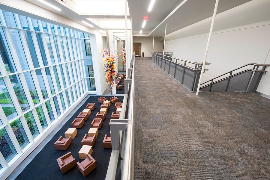 Photo of Lee Lobby from the second level with a view of the Chihuly artwork and the Brown Chairs