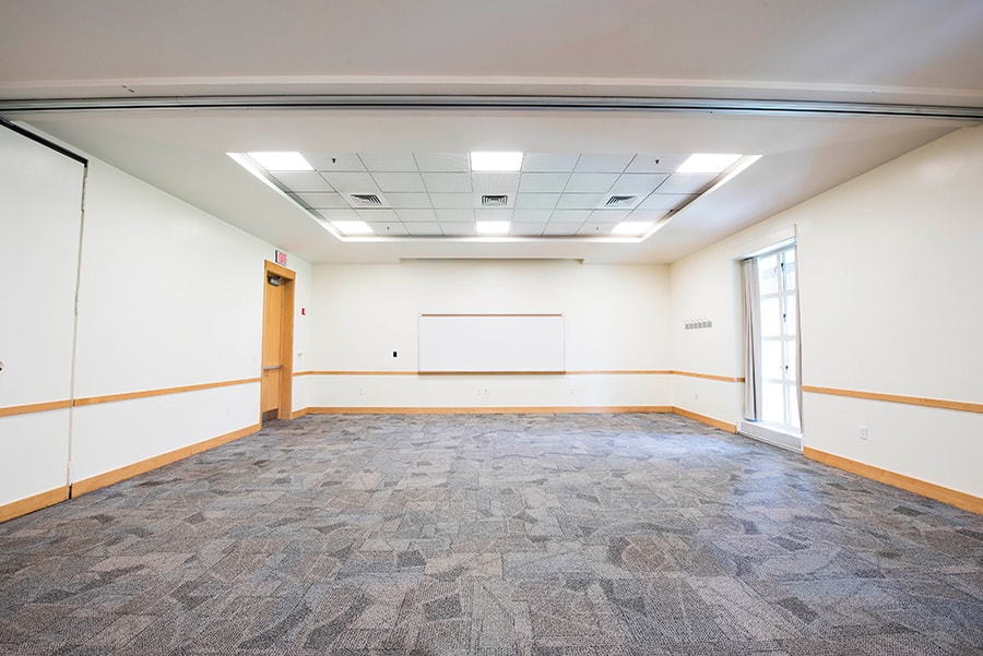 Photo of McKenna, Peter, and Wright room with a view of whiteboard and projection screen
