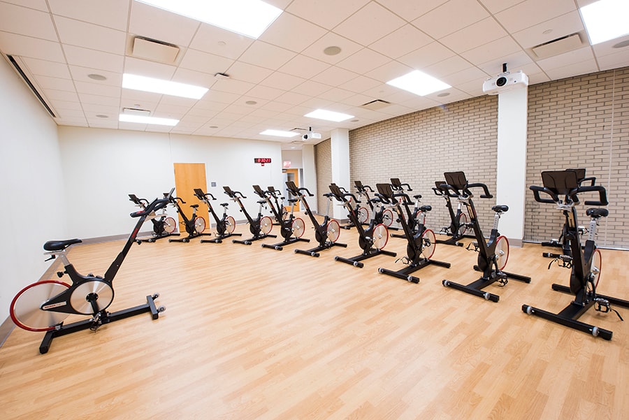Photo of Cycling Studio with view of instructor bike and projectors