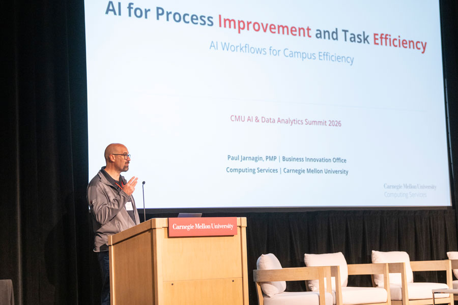 Paul Jarnagin at a Carnegie Mellon University podium, delivering a presentation on AI for process improvement and task efficiency.