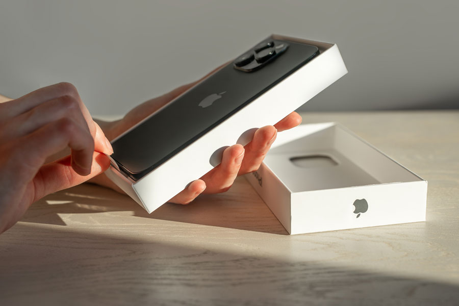 Person unboxing a new iPhone.
