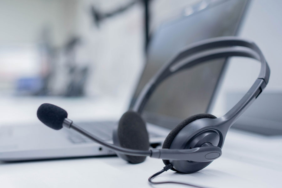 Photo of headphones with a microphone to signify the Help Center.