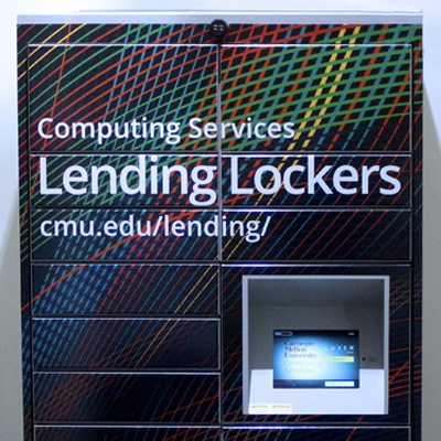 Image of the Lending Lockers, which feature a full-color tartan wave pattern, a touch screen keypad, and individual lockers controlled by the keypad.