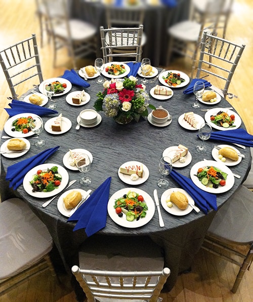 Decorative table with place settings and floral arrangement for a formal dinner event