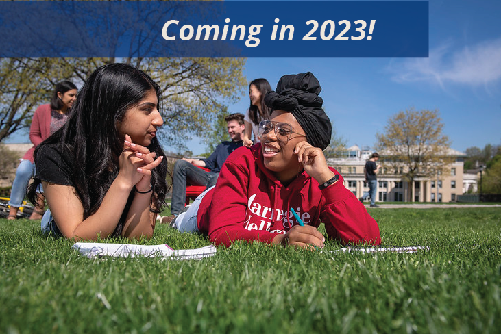 image of students discussing work in a grassy field