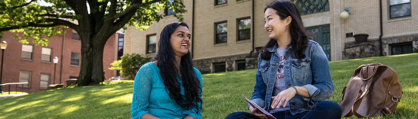 CMU students talking unmasked outside on campus.