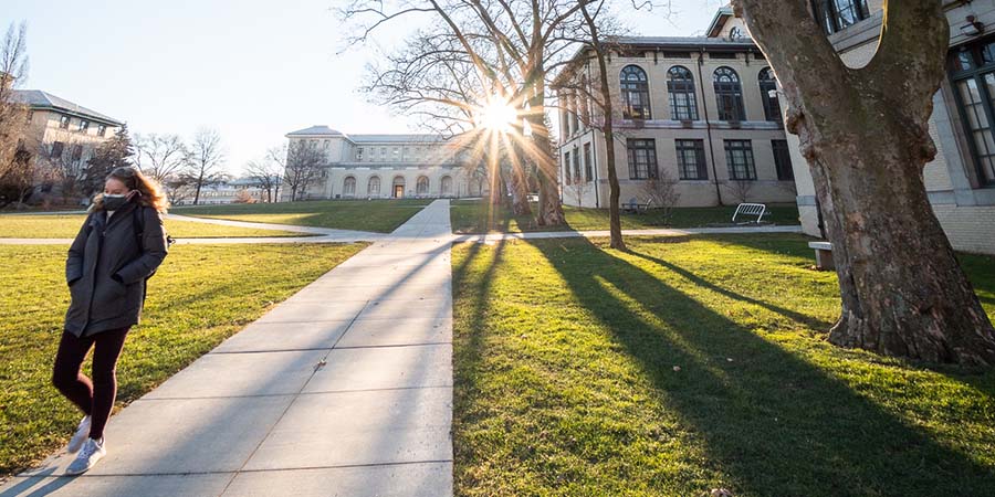 CMU student walking on campus in double masks in February 2021.