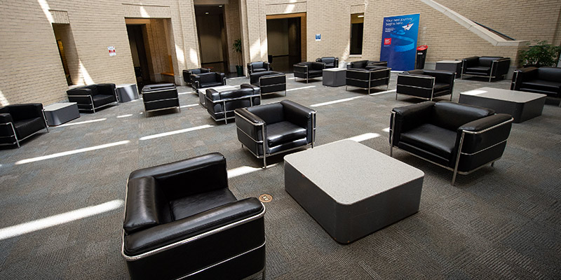 Photo of the black lounge chairs, spaced to account for physical distancing.