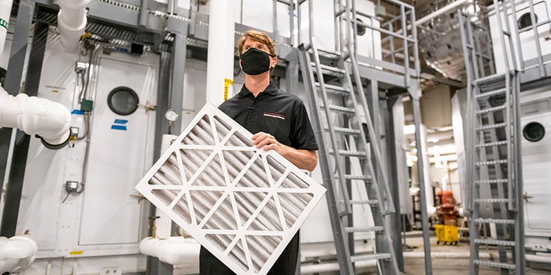 Photo of HVAC system and man with a filter
