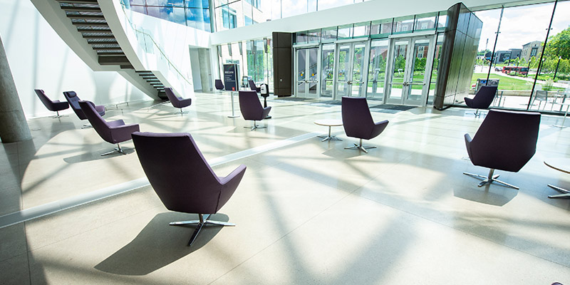 Photo of the purple lounge chairs in the Tepper building, spaced to account for physical distancing.