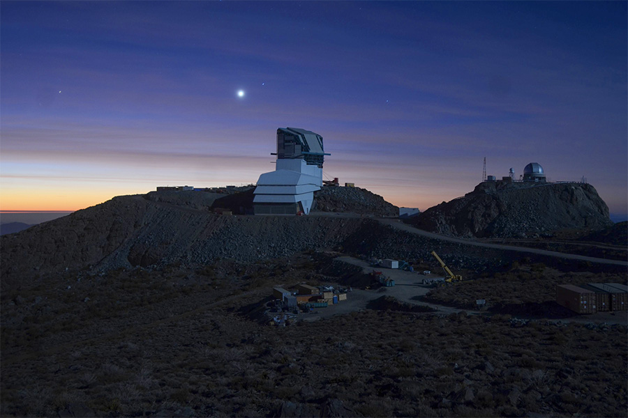 Rubin Observatory at sunset, lit by a full moon. Credit: Rubin Observatory/NSF/AURA