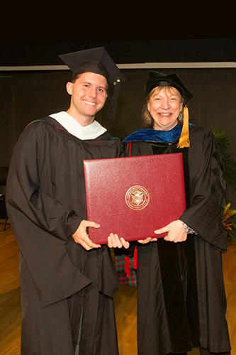 Graduate Alexander Helberg poses with Department Head Chris Neuwirth.