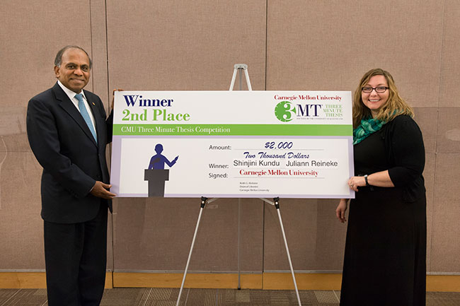 CMU president Suresh presents a $2,000 cash prize to LCS Ph.D. student Juliann Reineke.