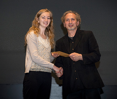 Student Alexandra George receiving an award from Peter Balakian.