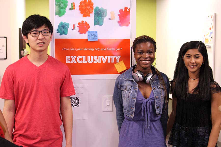 Students standing in front of poster about diversity.