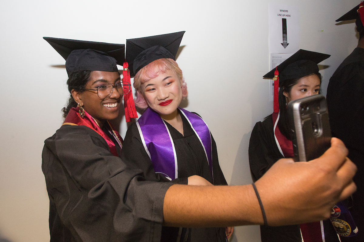 2019 graduates taking selfies.