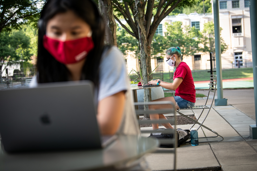 A photo displaying CMU students wearing masks and working on laptops