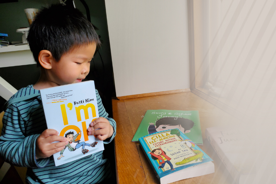 A photo of a child looking at books donated for the Upper Saint Clair book drive