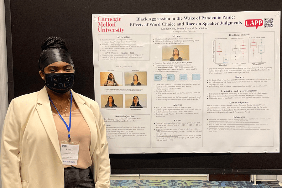 Kendyll Cole standing in front of a research poster at LSA 2022