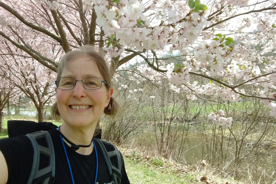 A photo displaying Barbara Litt underneath cherry blossom trees at North Park in Pittsburgh.