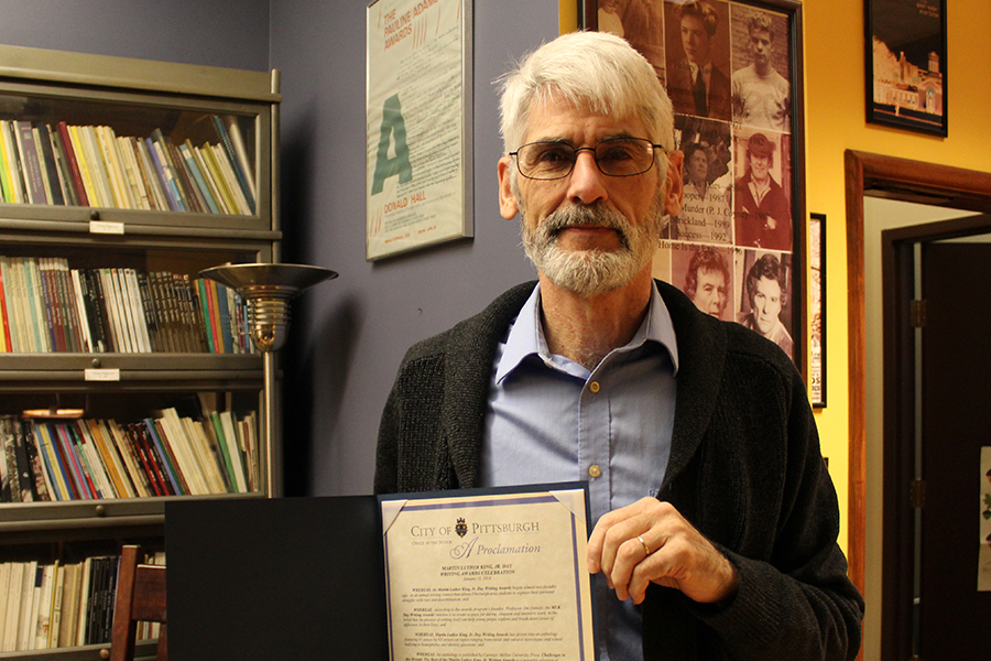 CMU professor and founder of the writing awards, Jim Daniels poses with the mayoral proclamation.