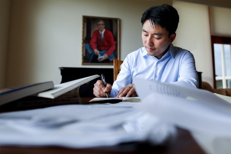 Junlei Li works in office at the Fred Rogers Center. Photo by Annie O'Neill.