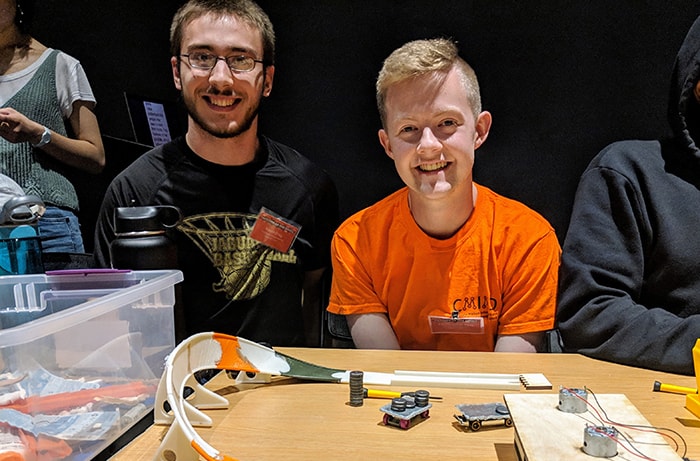 Sophomores Kevin Frey, a mechanical engineering major, and Christopher May, an information systems major, demonstrate the physics lesson of their interactive Matchbox car racetrack