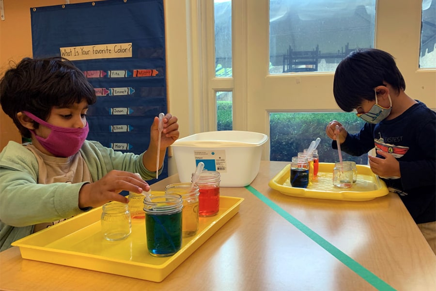 Children wearing masks, mixing colors