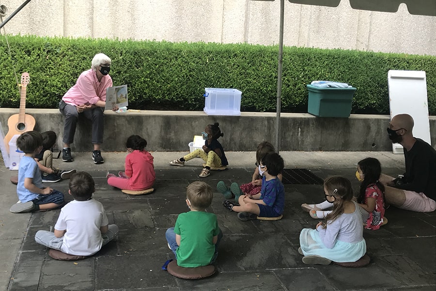 Children wearing masks, outside in a circle