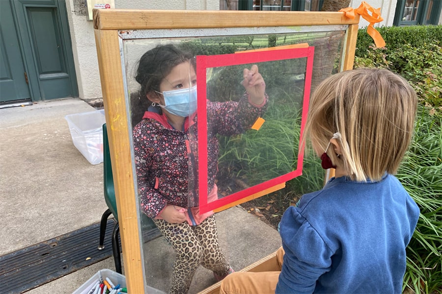 Children wearing masks, painting portraits