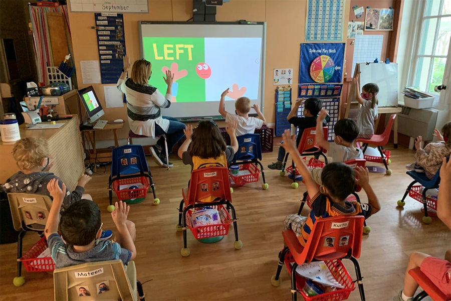 Children wearing masks, having circle time