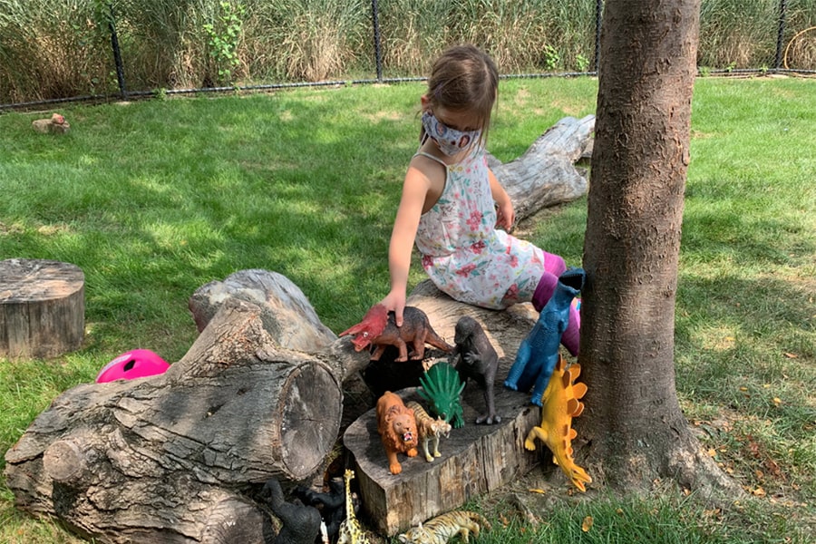 Child wearing a mask, playing outdoors