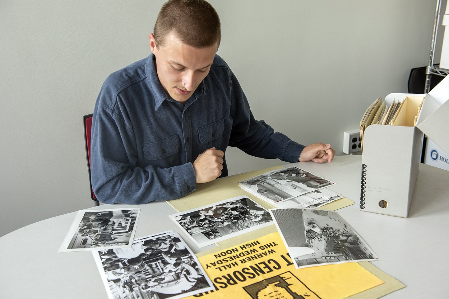 Nick Mlakar looking at photos on a desk