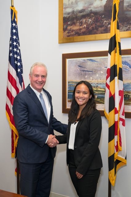 Abigail Khieu and Sen. Chris Van Hollen (D-MD) shake hands.