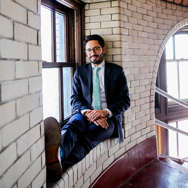 Michael Trujillo sitting on a window sill in Baker Hall