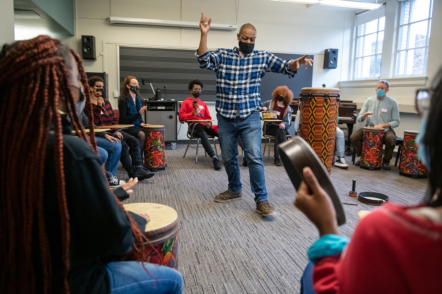 Local drummer Clarence Grant II leads high school students and others in a drum circle during a LEAP workshop on CMU's campus.