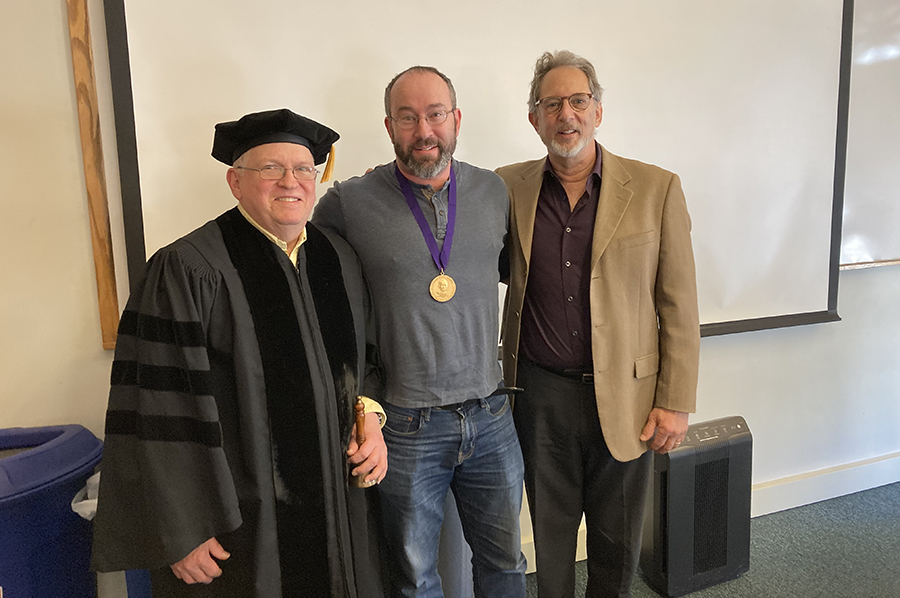 Danny Oppenheimer poses with senior faculty after receiving his award.