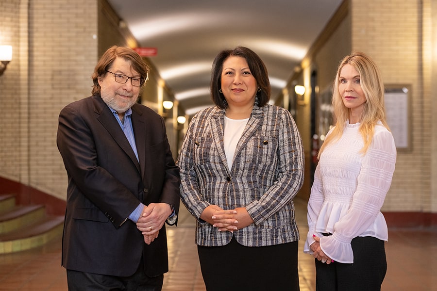 Mark Kamlet, Susan Baida and Lisa Nelson pose in Baker Hall.