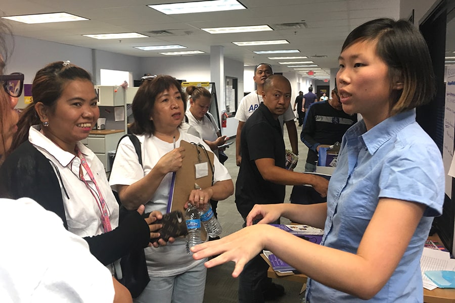 Vivian Chang talks with a crowd of AAPI workers.
