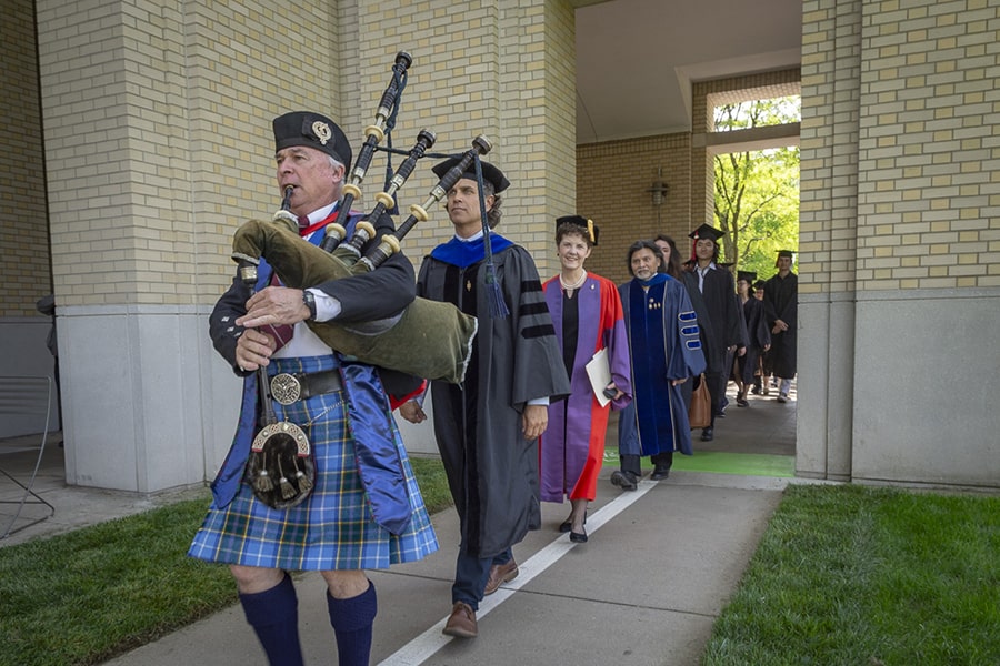 A bagpiper leads faculty and Phi Beta Kappa (PBK) inductees into the Cohon University Center.