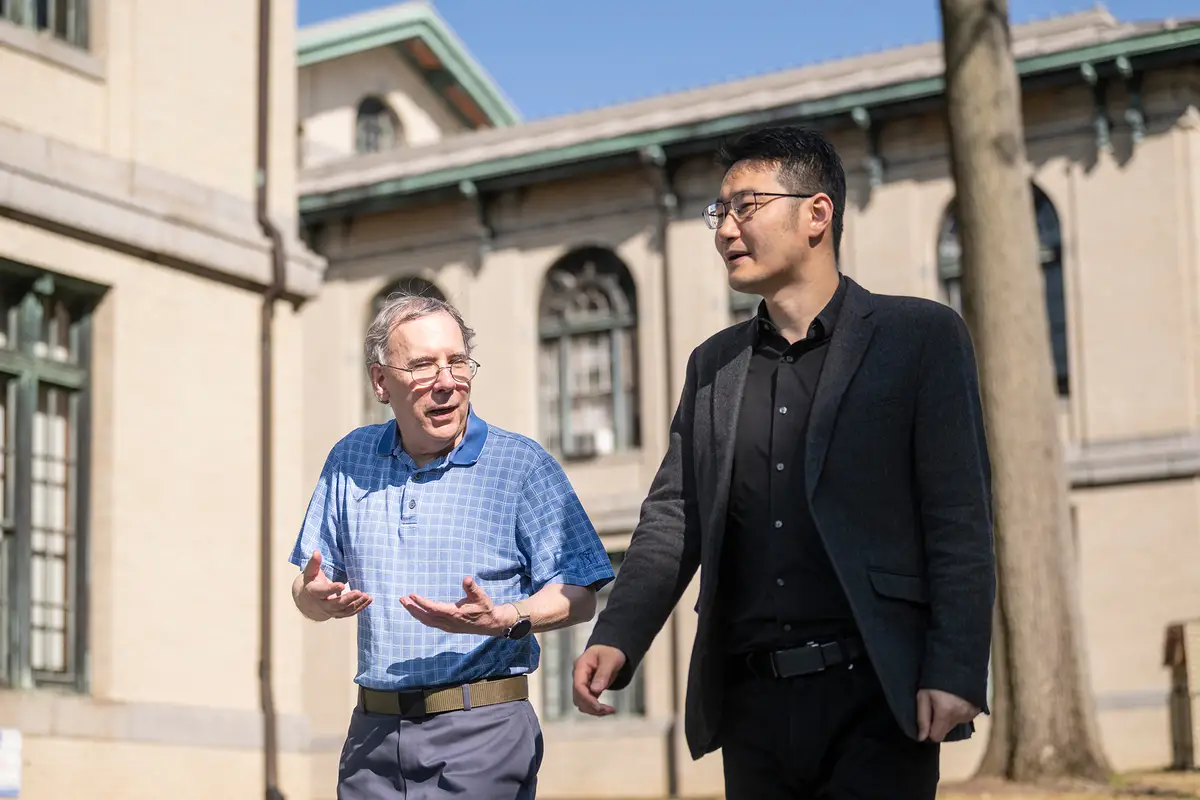 Marianna Brown Dietrich Professor and Head of Philosophy, Peter Spirtes, left, and Professor Kun Zhang talk on Thursday, September 18, 2025, while walking alongside at Baker Hall.