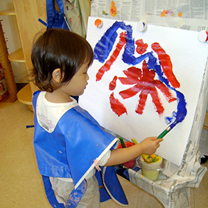 Child painting on an easel